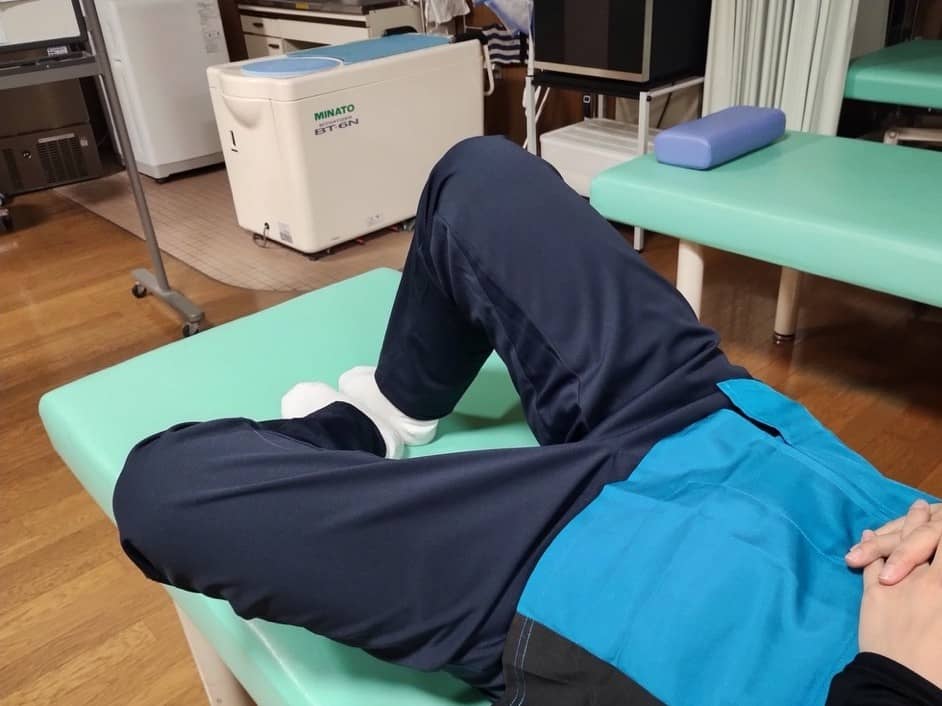 膝を立てて片足を片側に倒すトレーニングの様子2